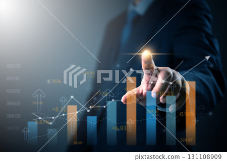 Businessman analyzing financial data on digital screen with growth chart. Great for business analytics, financial forecasting, investment growth, and market strategy visuals. Businessman analyzing financial data on digital screen with growth chart. Great for business analytics, financial forecasting, investment growth, and market strategy visuals. 131108909