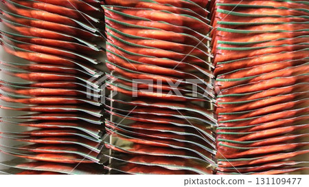 Abstract background of red and green tea bags in a large metallic wrapper, seen from above 131109477