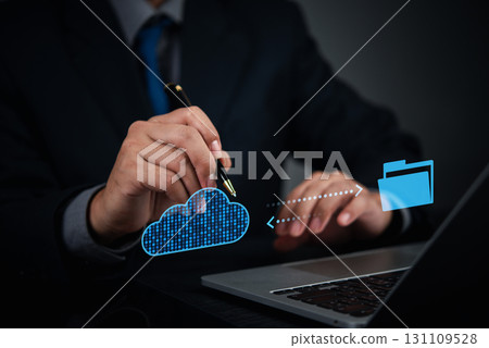 Businessman using cloud technology to transfer files to secure digital storage, concept for cloud computing solution and data backup. online management. Businessman using cloud technology to transfer files to secure digital storage, concept for cloud computing solution and data backup. online management. 131109528