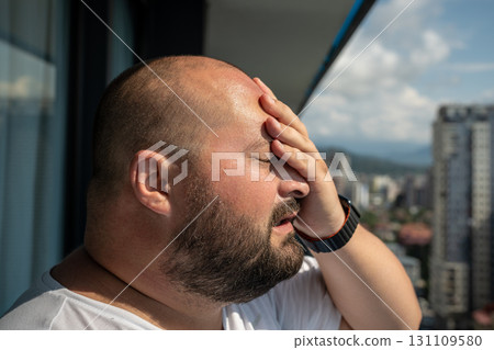 Portrait of overweight man has headache touching forehead in heat summer weather. Portrait of overweight man has headache touching forehead in heat summer weather. 131109580