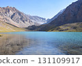 Idyllic summer landscape with hiking trail in the mountains with beautiful fresh green mountain pastures, lake with reflection. Alai ridge mountains 131109917