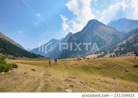 Idyllic summer landscape with hiking trail in the mountains with beautiful fresh green mountain pastures, National park. Nice view. Alai ridge mountains Idyllic summer landscape with hiking trail in the mountains with beautiful fresh green mountain pastures, National park. Nice view. Alai ridge mountains 131109928