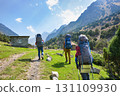 Idyllic summer landscape with hiking people in the mountains with beautiful fresh green mountain pastures and forest. Alai ridge mountains, Kyrgyzstan 131109930