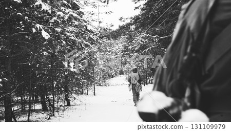Usa Army Soldiers Of World War Ii. Heroes Of War. Re-enactors Dressed As American Infantry Soldier Marching Through Forest Road In Cold Winter Day. Group Of Usa Soldiers Marching Country Road 131109979