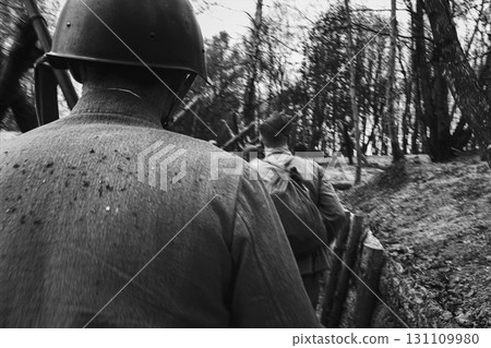 Re-enactors Dressed As Soviet Russian Soldiers take up fighting positions in trenches. Position Defense. Soldiers Aiming With Rifles. Reconstruction Of Battles World War Ii. Black And White Video 131109980