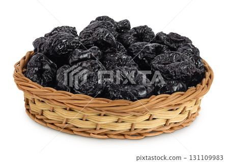 Prunes in a wicker basket isolated on white background, heap of dried plums 131109983