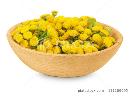 Tansy flower or Tanacetum vulgare in wooden bowl isolated on white background 131109995
