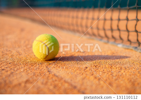 Tennis ball and net. Ground court for tennis. Sports equipment for an active lifestyle. 131110112