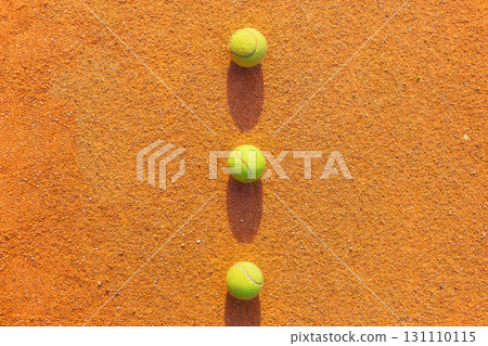 Tennis ball on the ground tennis court. Sports equipment for an active lifestyle. Tennis ball on the ground tennis court. Sports equipment for an active lifestyle. 131110115
