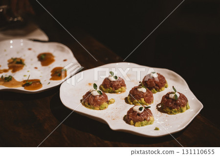Elegant Plating of Tuna Tartare with Avocado and Garnish Elegant Plating of Tuna Tartare with Avocado and Garnish 131110655