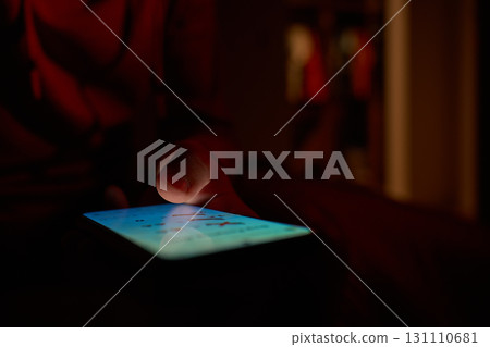 Hand using smartphone in dark room Hand using smartphone in dark room 131110681