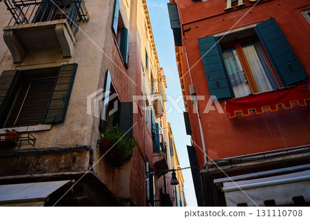 Narrow street with historic buildings and open windows in Venice Narrow street with historic buildings and open windows in Venice 131110708
