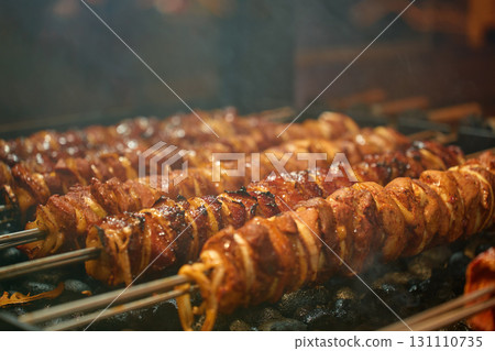 Grilled meat skewers with onion cooking on charcoal barbecue Grilled meat skewers with onion cooking on charcoal barbecue 131110735