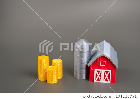 Miniature farm stacks of coins. Government support, financial aid, and subsidies for small or local agricultural businesses. Capital investment, financial growth, and rural development opportunities. 131110751