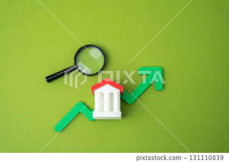 Bank building and green up arrow. Growth of savings in the bank account. Rising bank capitalization, deposit growth, increasing consumer savings. Business and finance. Magnifying glass 131110839