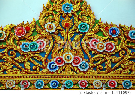 Traditional thai art showing colorful flowers and golden details decorating a temple 131110973
