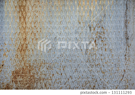 Texture of a ribbed, rusty metal surface with a diamond pattern 131111293