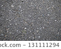 Texture, background of dark asphalt with small stones and cracks 131111294