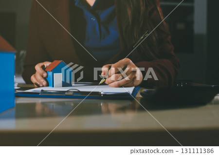 Customer signing a real estate contract in real estate agency. Customer signing a real estate contract in real estate agency. 131111386