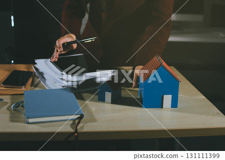 Customer signing a real estate contract in real estate agency. Customer signing a real estate contract in real estate agency. 131111399