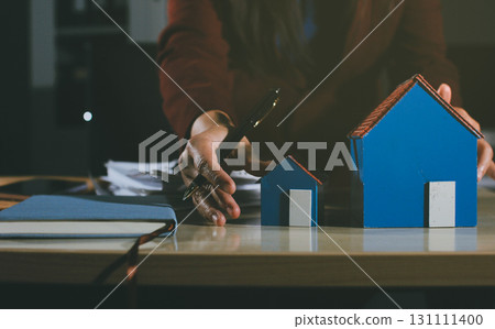 Customer signing a real estate contract in real estate agency. 131111400