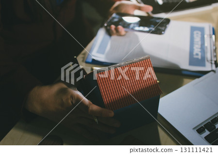 Customer signing a real estate contract in real estate agency. Customer signing a real estate contract in real estate agency. 131111421