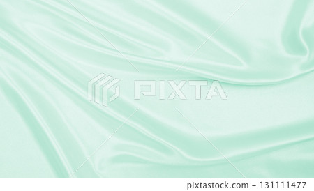 Smooth elegant green silk or satin luxury cloth texture as abstract background. Luxurious background design 131111477