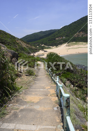 A path leading between mountains to a sandy beach in the bay of the South China Sea in Vietnam 131113504