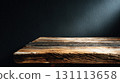Wooden Table Against Dark Black Wall in Minimalist Room Setting 131113658