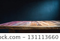 Rustic Wooden Table Against Dark Wall in Dimly Lit Room 131113660