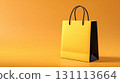 Stylish Yellow Gift Bag with Black Handles on Clean Background 131113664