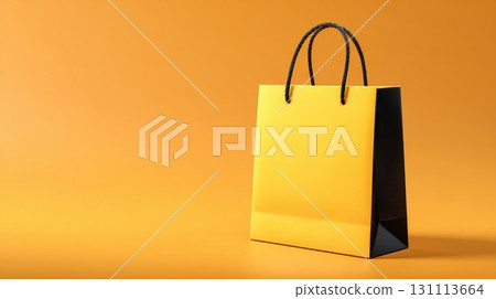 Stylish Yellow Gift Bag with Black Handles on Clean Background 131113664