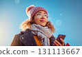 Young Woman Christmas Shopping Outdoors with Phone in Hand 131113667