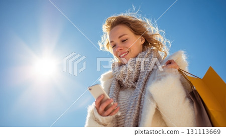 Young Woman Smiling While Christmas Shopping and Gazing at Phone Young Woman Smiling While Christmas Shopping and Gazing at Phone 131113669