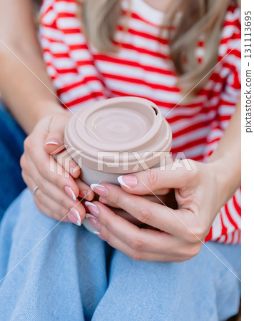 Mother with child holds in hands cup of coffee Mother with child holds in hands cup of coffee 131113695