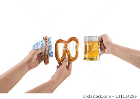 Human hands holding a sausage with a blue checkered tablecloth or napkin, pretzel loaf, and beer mug isolated over a white background. Oktoberfest festival 131114289