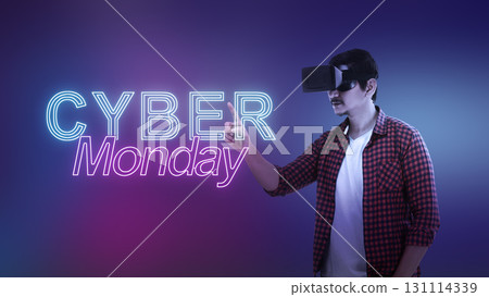 Indonesian southeast asian man in virtual reality glasses touching a text of Cyber Monday on a color gradient background. Copy space. Cyber Monday sale concept Indonesian southeast asian man in virtual reality glasses touching a text of Cyber Monday on a color gradient background. Copy space. Cyber Monday sale concept 131114339