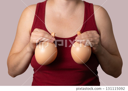 Comparing Balloons to Breasts With Tank Top Woman for Cosmetic Surgery 131115092