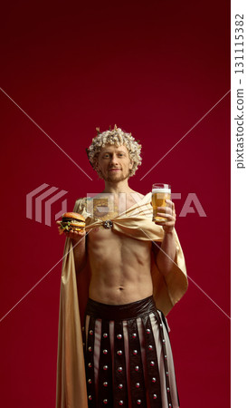 Roman man in toga smiling with beer glass and burger in hands 131115382