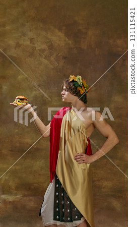 Man in toga presenting burger on hand with serious confident posture 131115421