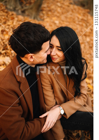 Young couple in love walking in the park on a autumn day. Enjoying time together. Young couple in love walking in the park on a autumn day. Enjoying time together. 131115748