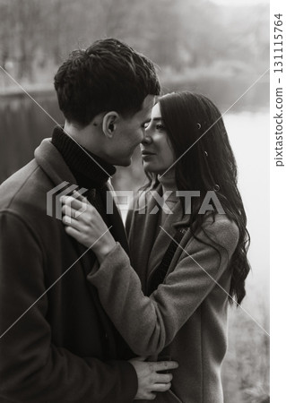 Young couple in love walking in the park on a autumn day. Enjoying time together. 131115764