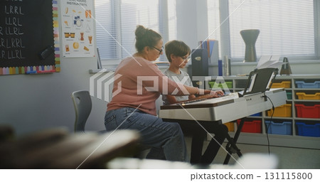 Talented Boy Playing Piano During Music Lesson, Rehearsing Before Musical Performance 131115800