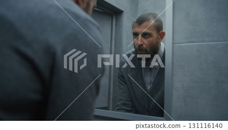 Male Office Worker Looking in the Mirror, Washing His Hands. Hand Hygiene after Using the Toilet 131116140