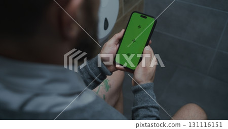 Businessman Sitting on the Toilet, Using Smartphone with Green Screen Businessman Sitting on the Toilet, Using Smartphone with Green Screen 131116151