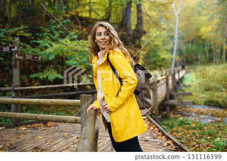 Portrait of young woman walking in the forest. Travelling, lifestyle, adventure. Portrait of young woman walking in the forest. Travelling, lifestyle, adventure. 131116399