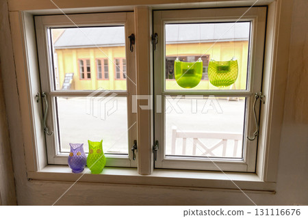 Close window in Scandinavian style decorated with candlesticks. Close window in Scandinavian style decorated with candlesticks. 131116676