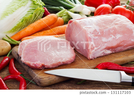 Vegetables and pork meat on cutting board 131117103