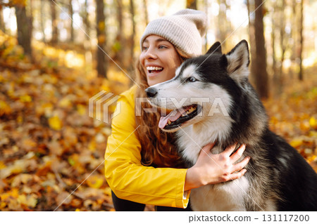 A pet owner spends time with her dog. Concept of fun, entertainment. 131117200