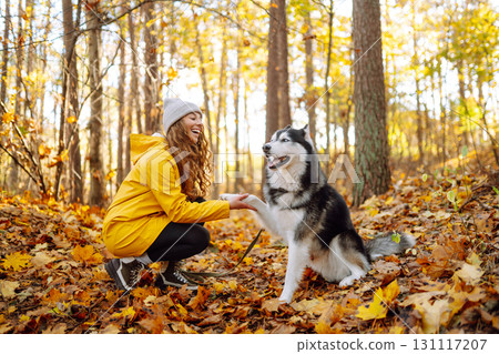 A pet owner spends time with her dog. Concept of fun, entertainment. 131117207